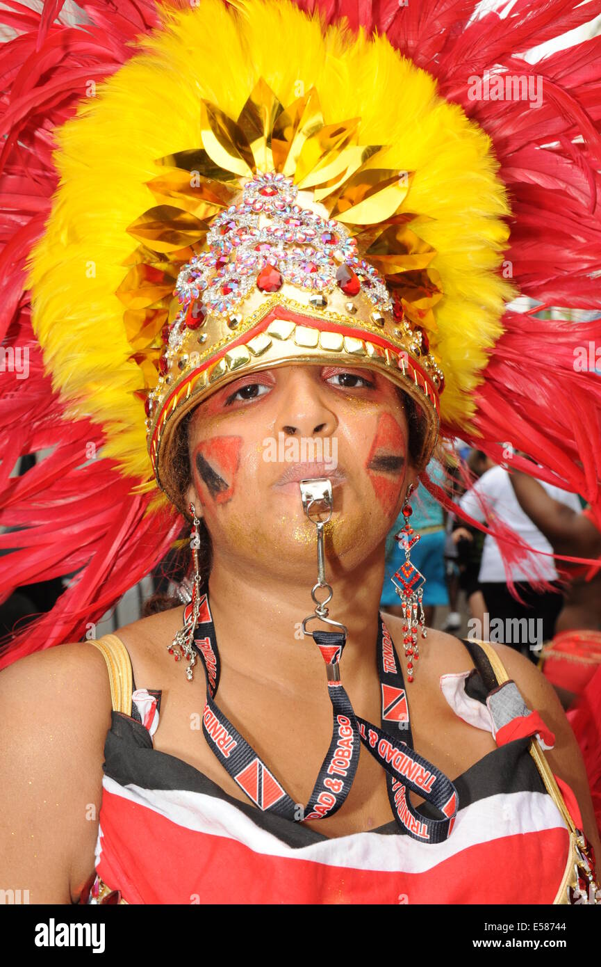 Notting Hill Festival women in Headdress Blowing a whistle Stock Photo