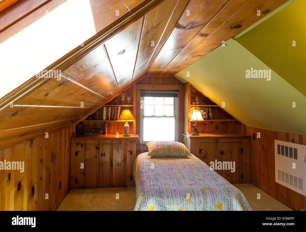 Wood Paneled Attic Bedroom with Slanted Ceiling,  Single Bed, Interior, Residential House, USA Stock Photo
