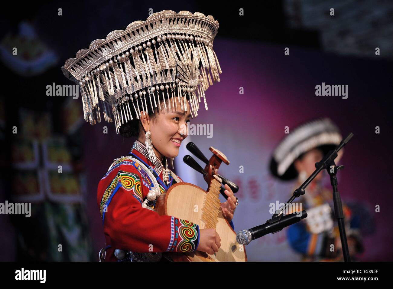 Xichang, China's Sichuan Province. 23rd July, 2014. A woman of the Yi ethnic group performs during a talent show of a traditional beauty contest at Xichang City, southwest China's Sichuan Province, July 23, 2014. The beauty contest is one of the most important activities during the annual Torch Festival at Liangshan Yi Autonomous Prefecture. It can date back to over 1,000 years ago in the history of the Yi ethnic group. © Xue Yubin/Xinhua/Alamy Live News Stock Photo