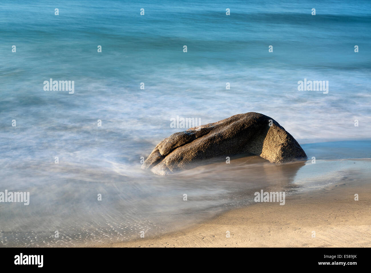 Rock with moving ocean water. Stock Photo