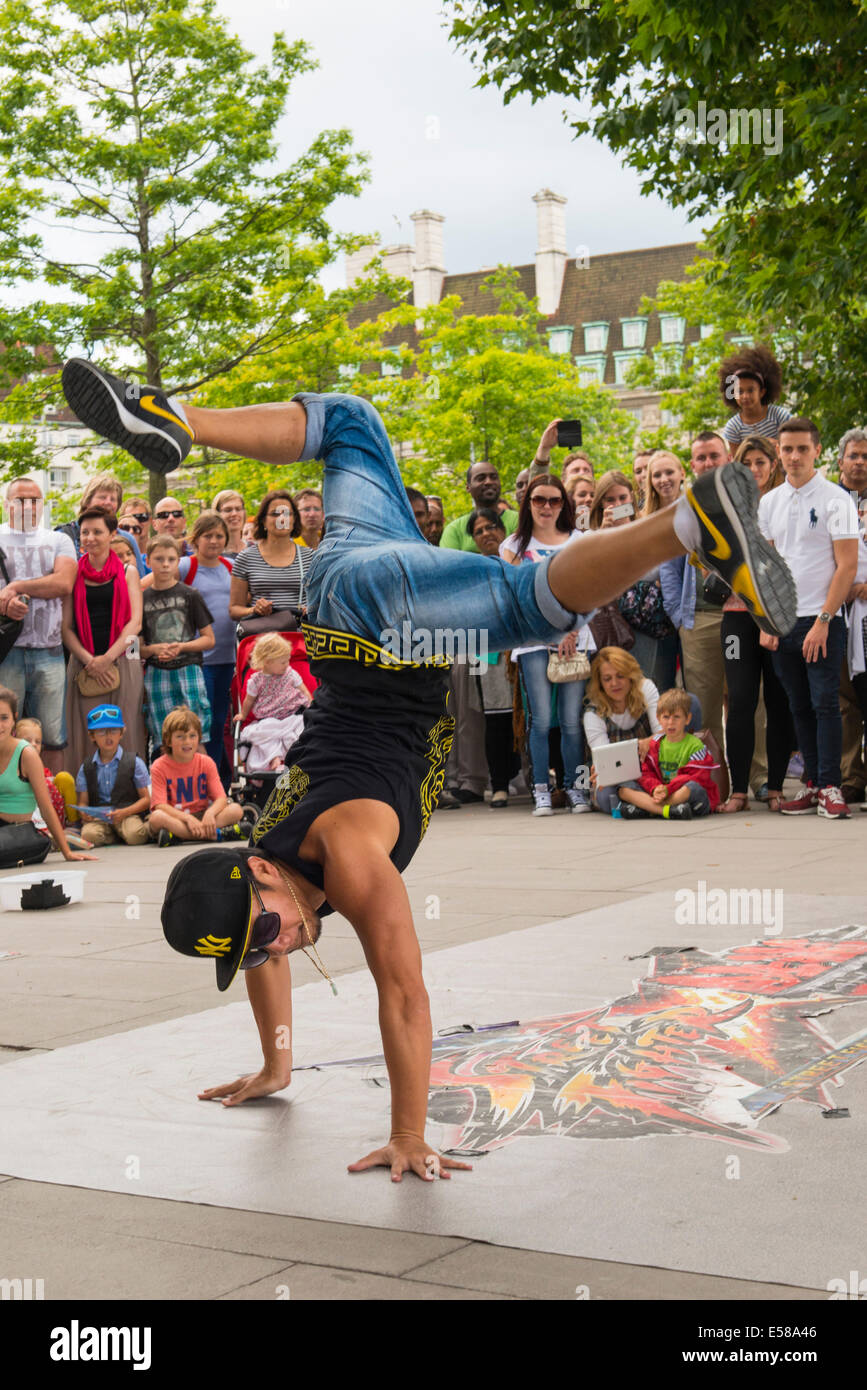 London , Southbank , amazing superb acrobatic modern street dancer dancers busk buskers crowds people tourists for money Stock Photo