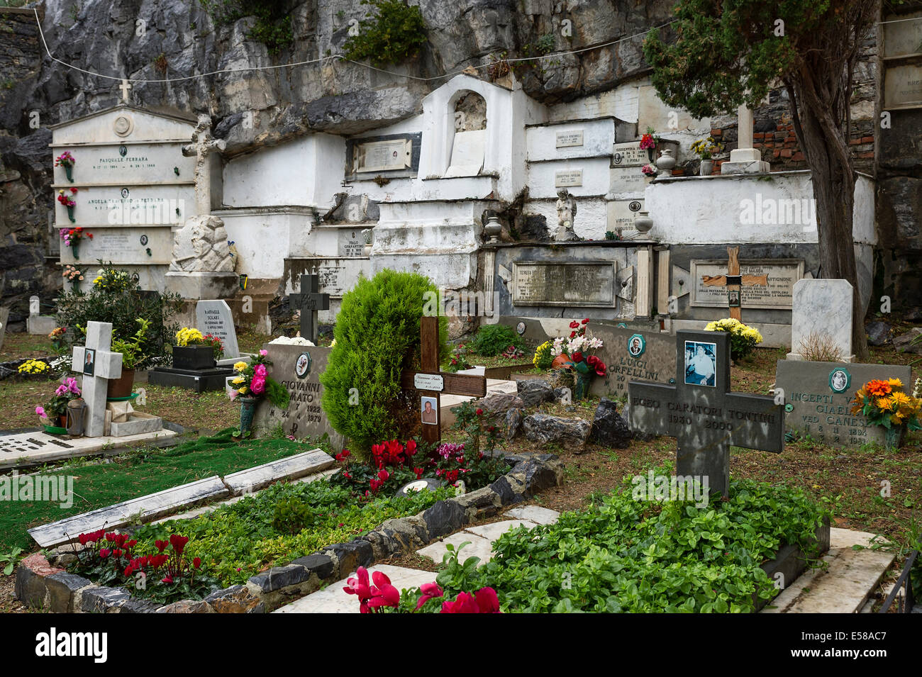 Fresh flowers adorn graves and burial vaults of the village cemetery, Porto Venere, Italy Stock Photo