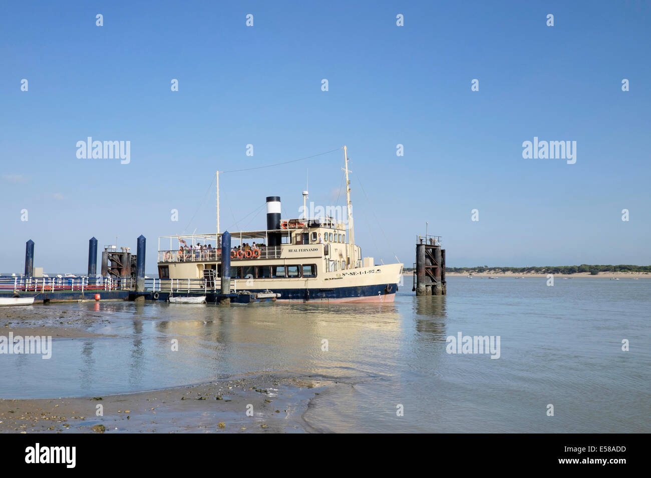 Ferryboat sets off from Sanlucar de Barremeda to cross the Guadalquivir river the Coto Dona Ana nature reserve Stock Photo