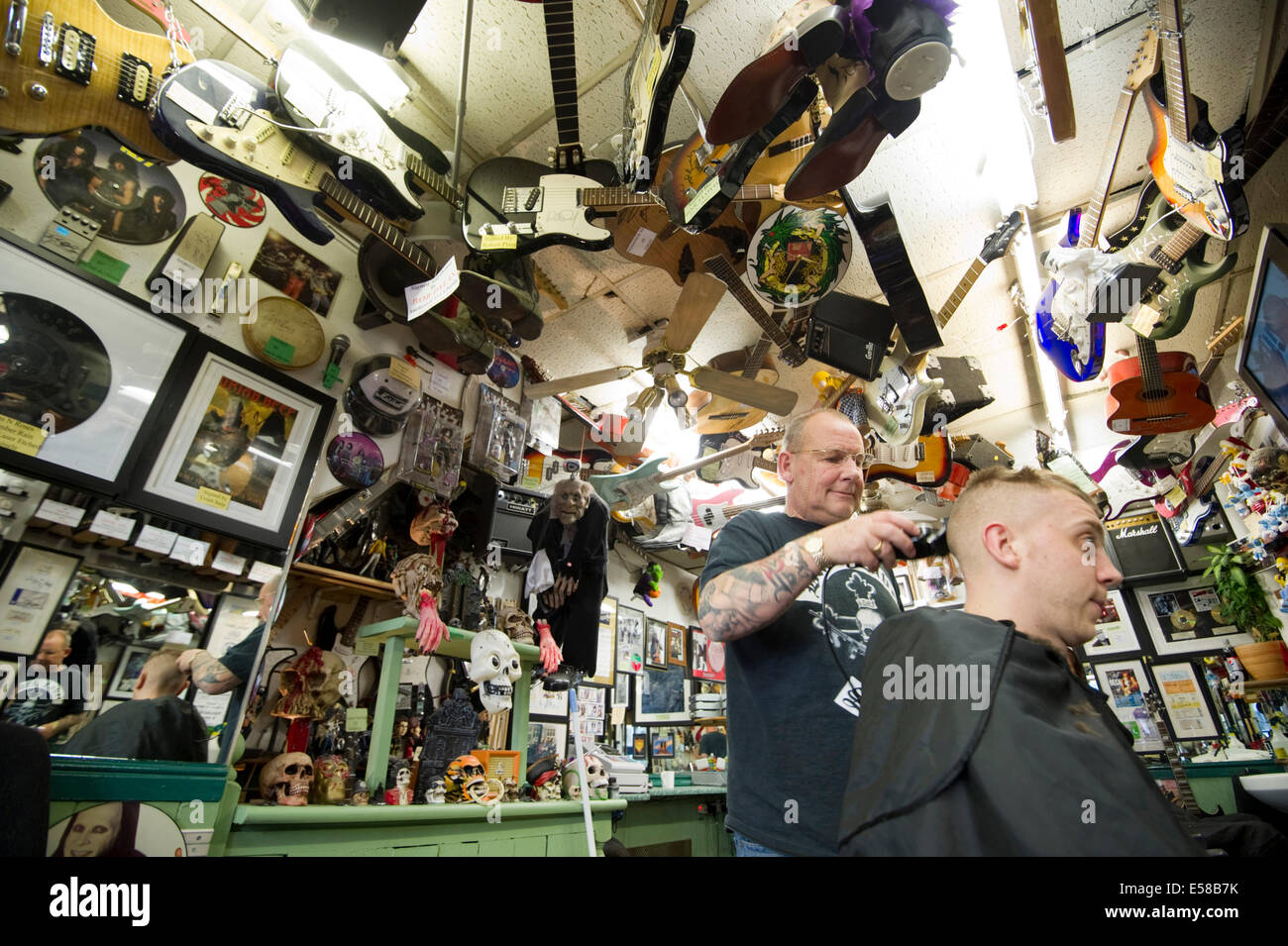 .Beards 'n' Barnets Barbershop. 53 yr old Geoff Cole a rock nut who has turned his barbershop into a rock music mecca Stock Photo