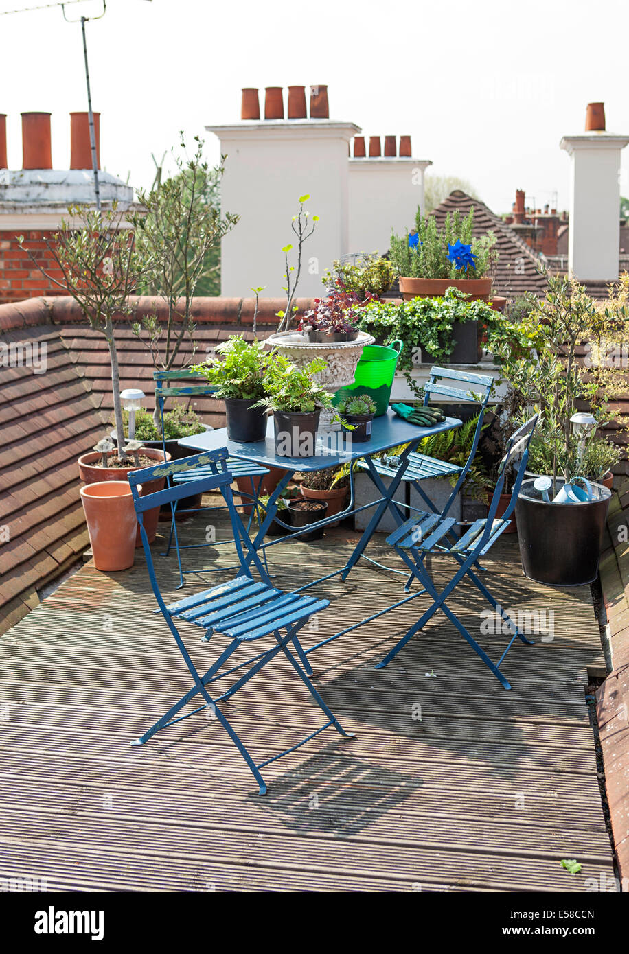 Blue table and chairs on rooftop garden in Primrose Hill, London, UK