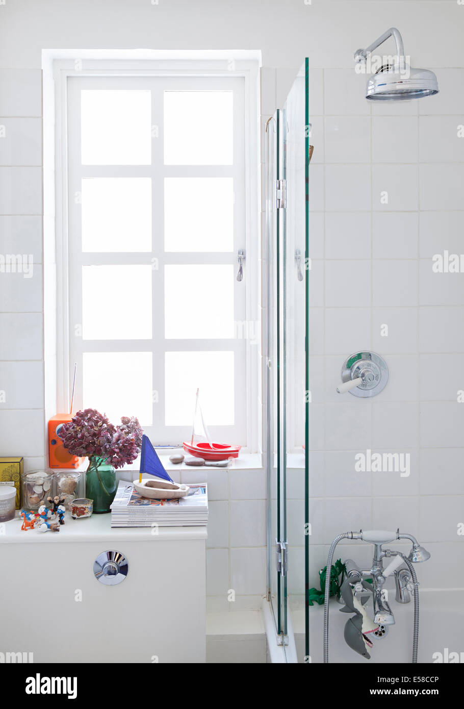 Shower over bath in modern bathroom, Primrose Hill, London, UK Stock Photo