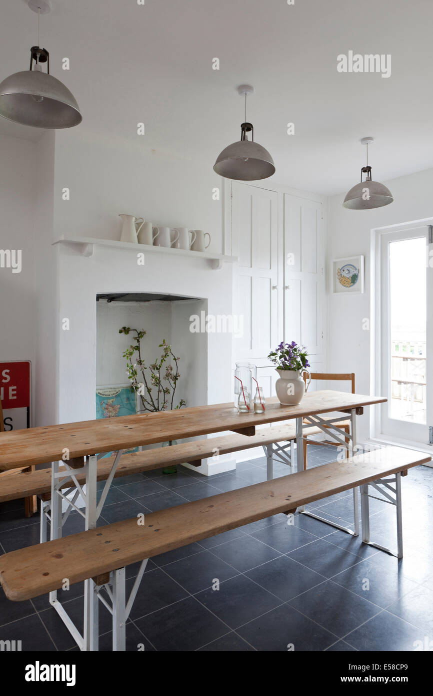 Wooden table and benches in dining room of beach house, Sandways, Camber Sands, UK. Stock Photo