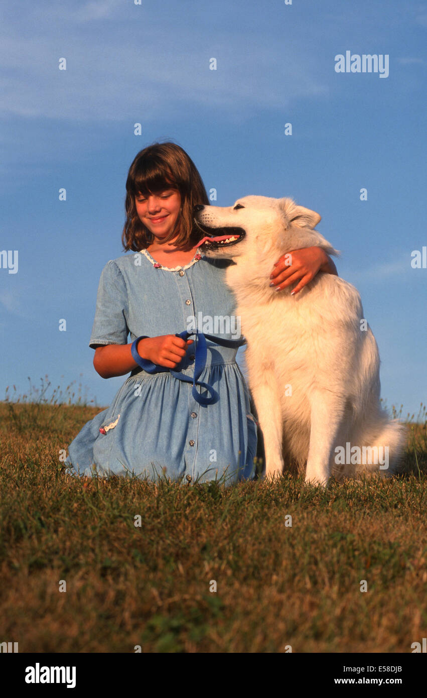 Beautiful young girl posing with pet dog. Stock Photo
