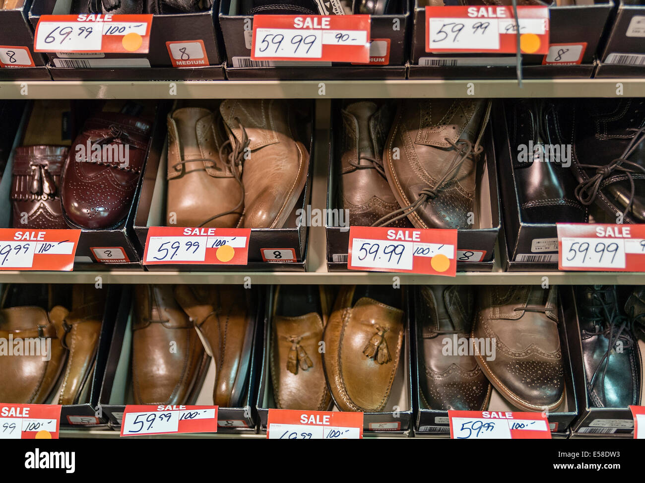 Men's shoes discounted in a store sale. Stock Photo