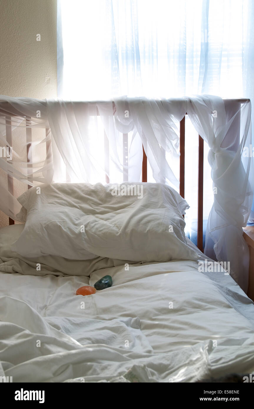 A Simple Bedroom Under Ambient Light From The Window Coming