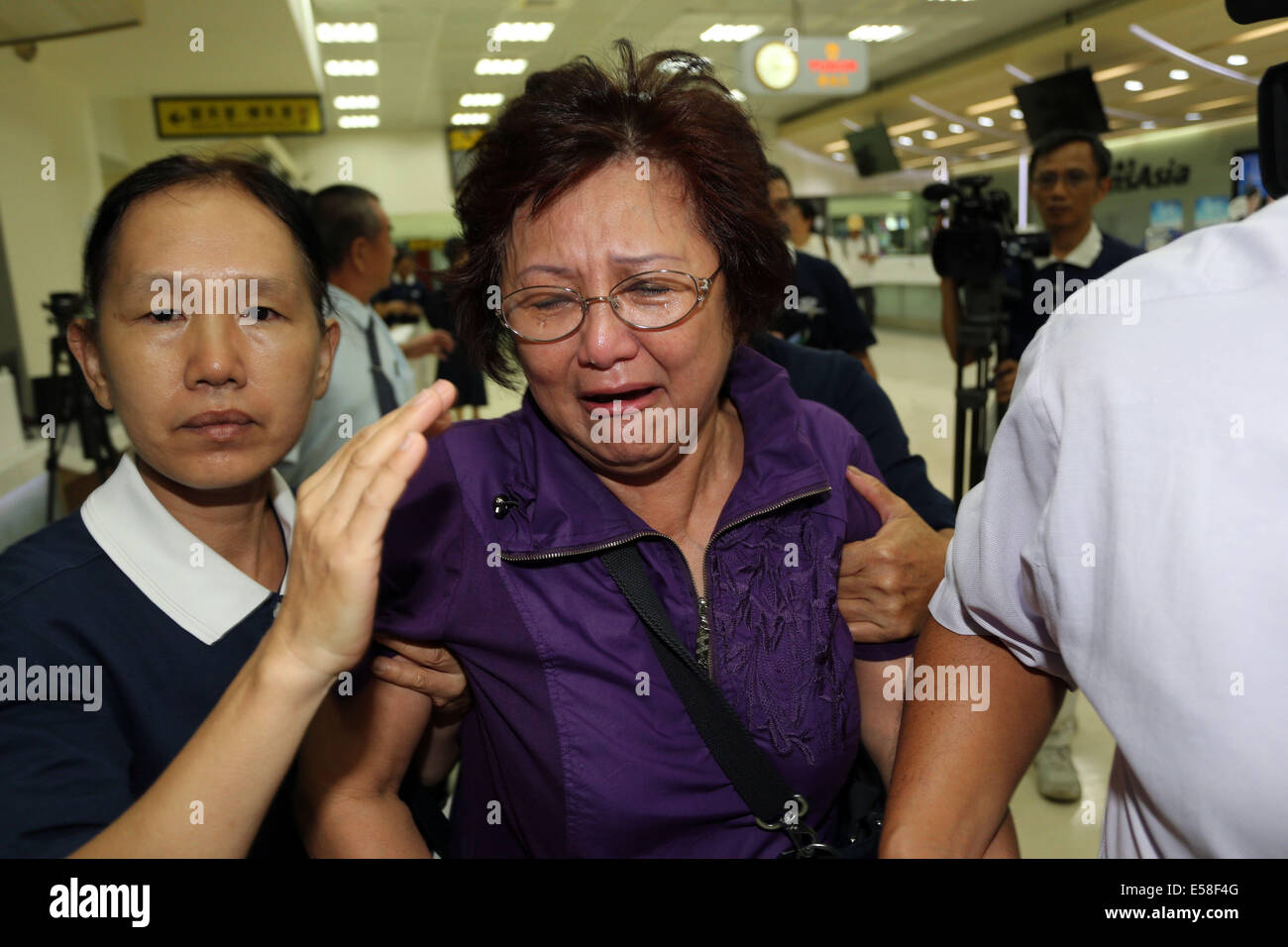 Kaohsiung, Taiwan. 23rd July, 2014. Relatives of passengers onboard TransAsia Airways' flight GE222, which ended up in a failed emergency landing, are seen at Kaohsiung International Airport in Kaohsiung, southeast China's Taiwan, July 23, 2014. Forty-seven people onboard the airliner were killed after a failed emergency landing in the island county of Penghu on Wednesday, Taiwan's transportation authority has confirmed. The twin-engine ATR-72 turboprop aircraft was carrying 54 passengers and four crew. Credit:  Xinhua/Alamy Live News Stock Photo
