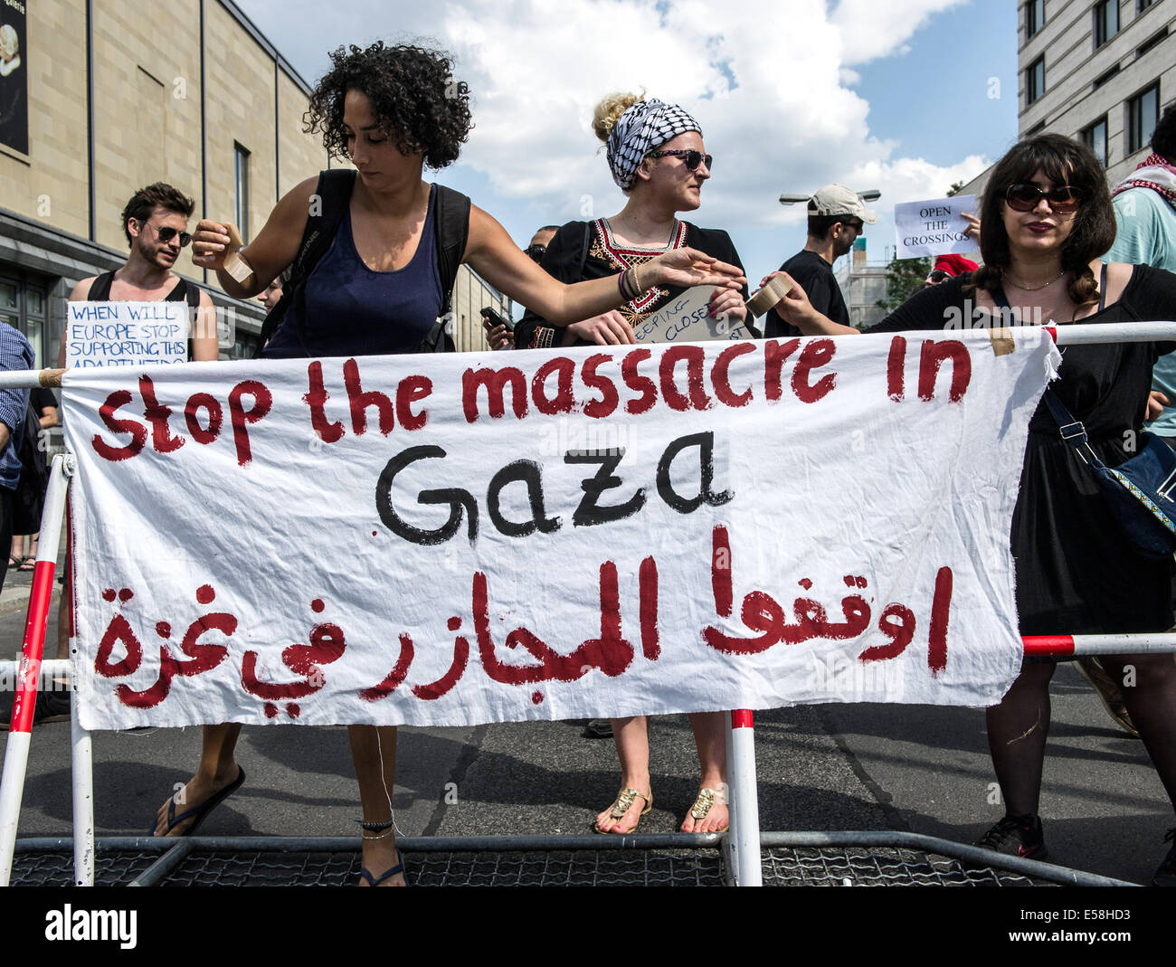 Berlin, Germany. 23rd July, 2014. Demonstrators with a banner reading 'Stop the massacre in Gaza' protest against the closing of the border to the Gaza Strip by Egypt at the Egyptian embassy in Berlin, Germany, 23 July 2014. Photo: Paul Zinken/dpa/Alamy Live News Stock Photo