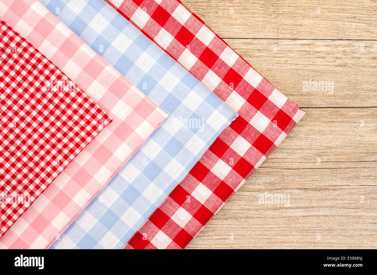 Stack of checkered cloth in red, blue and pink Stock Photo - Alamy