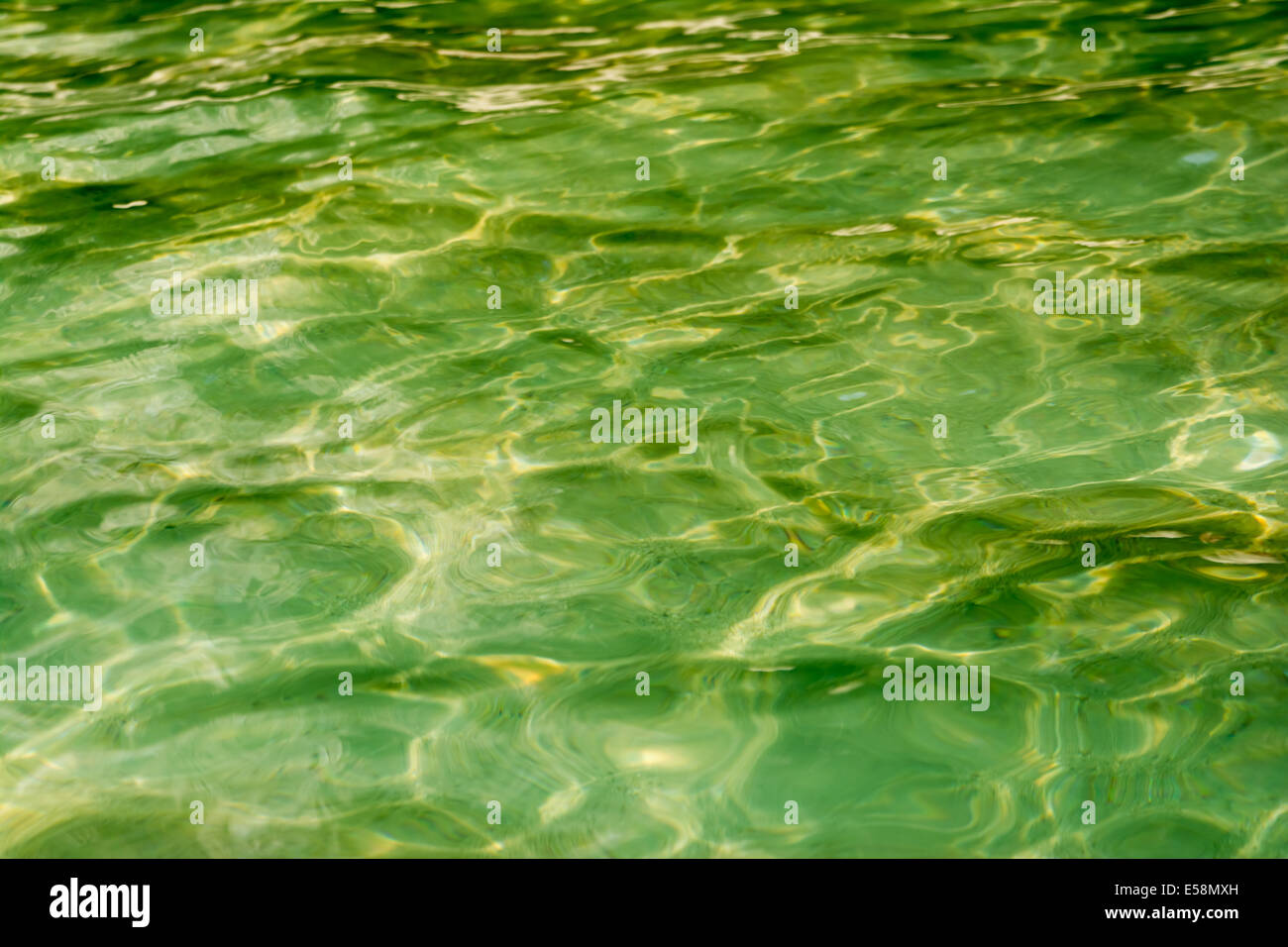 Background texture of a crystal green water in a paradise tropical island in Thailand Stock Photo