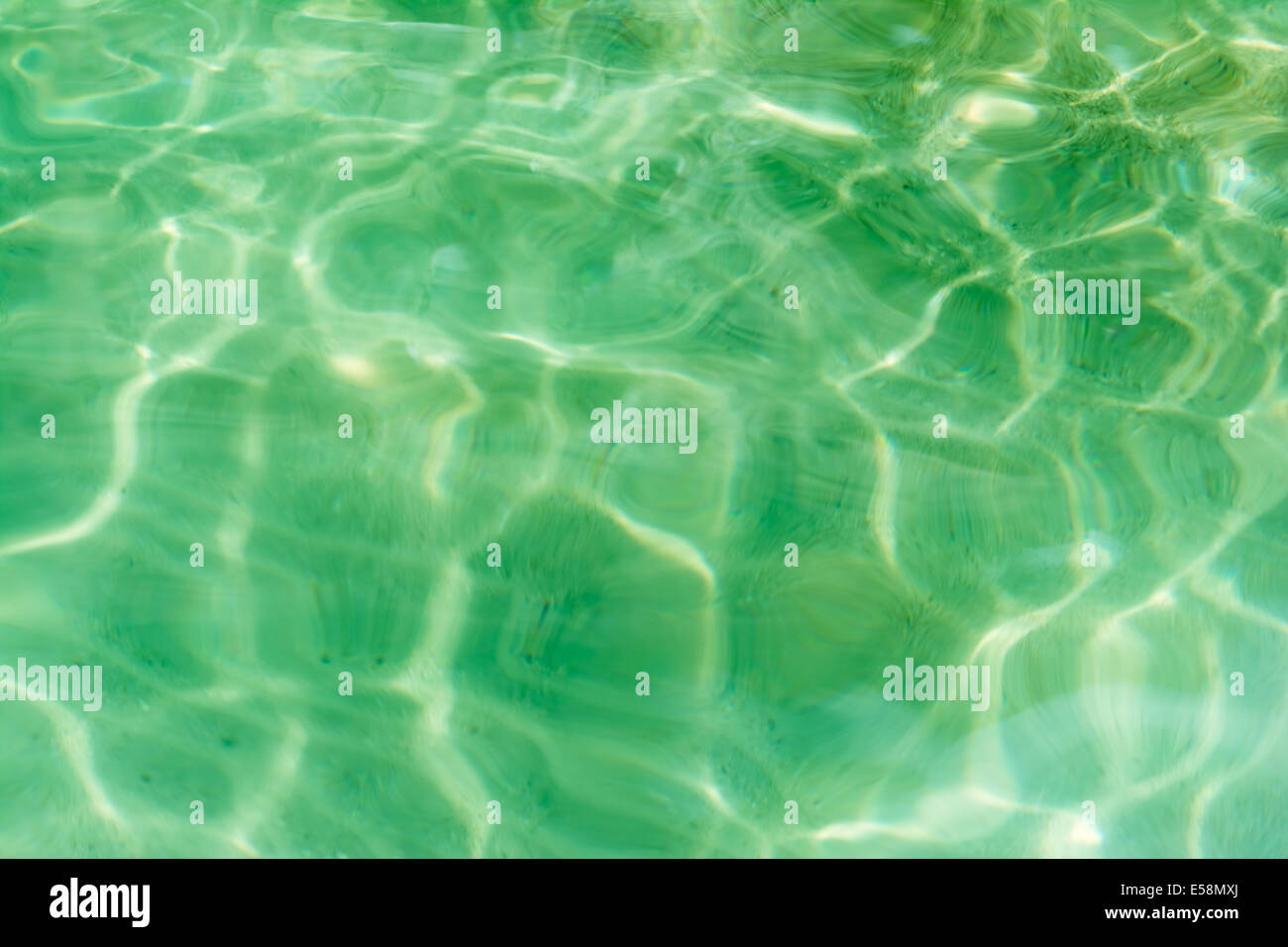 Background texture of a crystal green water in a paradise tropical island in Thailand Stock Photo