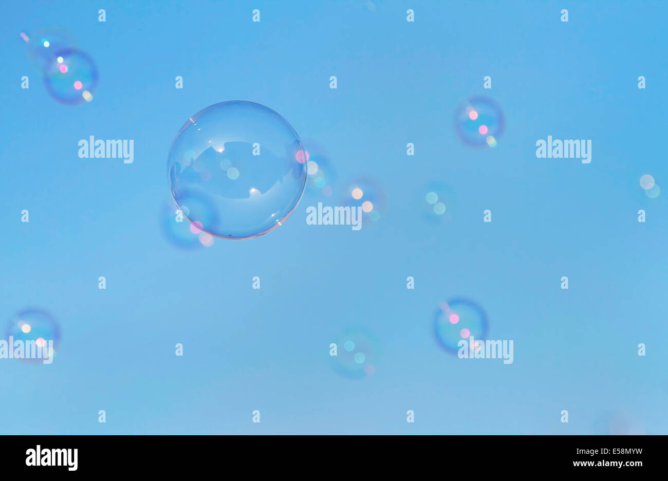 Soap bubbles floating in a blue sky Stock Photo - Alamy