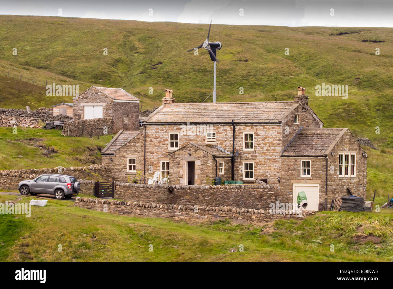 A remote moorland house at the head of Allen Dale, powered by a wind turbine, northumberland, UK. The house is at around 550 metres above sea level Stock Photo