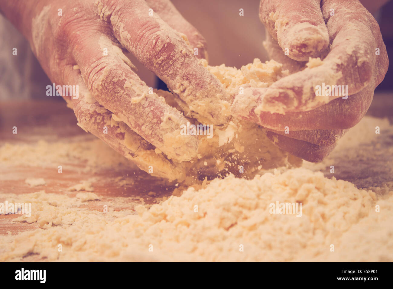 Closeup photo of baker making yeast dough for bread. Retro styled ...