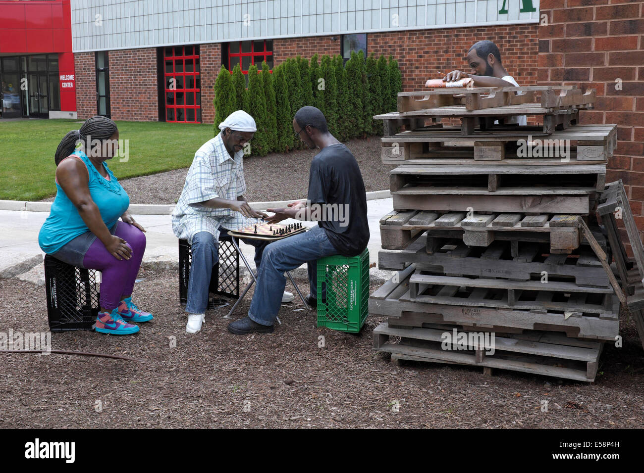 No Way - two African American men playing chess while others look on - Sculpture by Seward Johnson Stock Photo