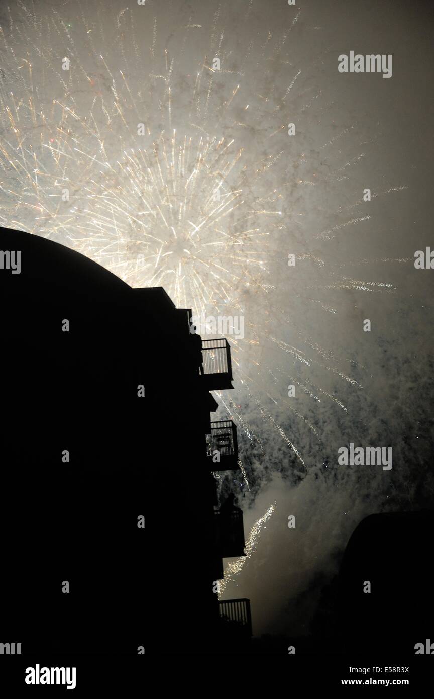 Glasgow, UK. 23rd July, 2014. Fireworks from the opening ceremony of the Commonwealth Games explode in the sky as Gorbals residents watch from their balconies. Credit:  Tony Clerkson/Alamy Live News Stock Photo