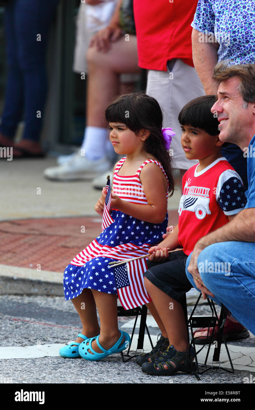 Caucasian girl in crowd wearing stars and stripes clothing during 4th July Independence Day parades, Catonsville, Maryland, USA Stock Photo