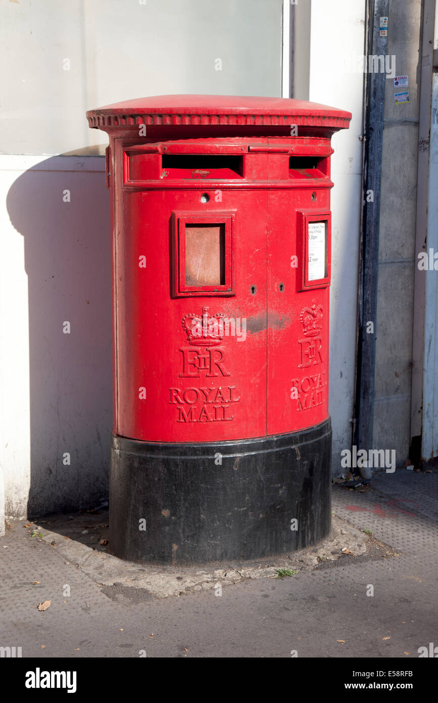 Modern pillar style red British post box in Kentish Town Stock Photo