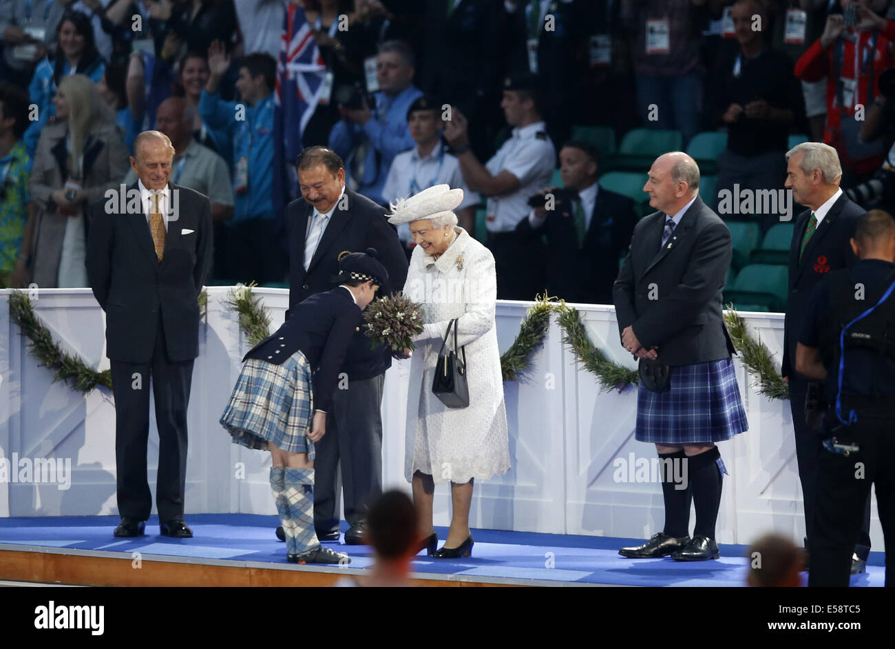 Glasgow, Scotland, UK. 23rd July, 2014. Britain's Queen Elizabeth II receives flowers from a child during the opening ceremony of the XX Commonwealth Games at the Celtic Park in Glasgow July 23, 2014. Credit:  Wang Lili/Xinhua/Alamy Live News Stock Photo