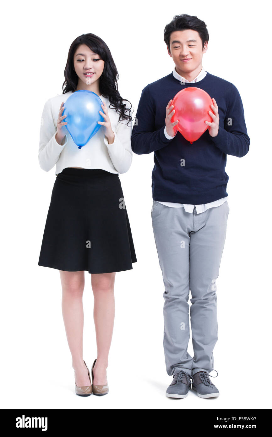 Happy young couple with balloons Stock Photo - Alamy
