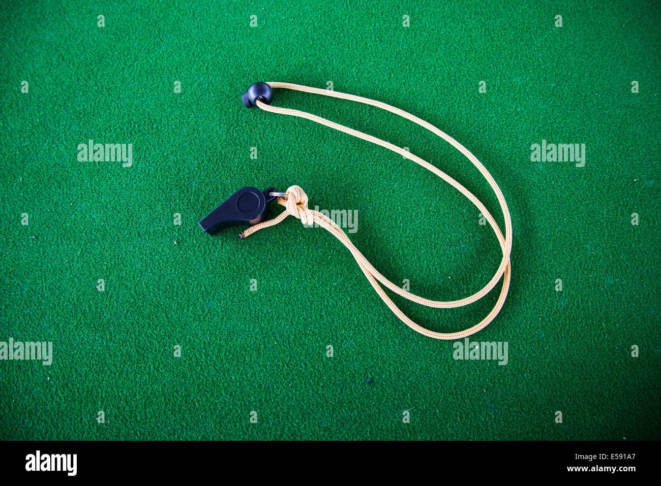 The whistle on the green carpet background. Stock Photo