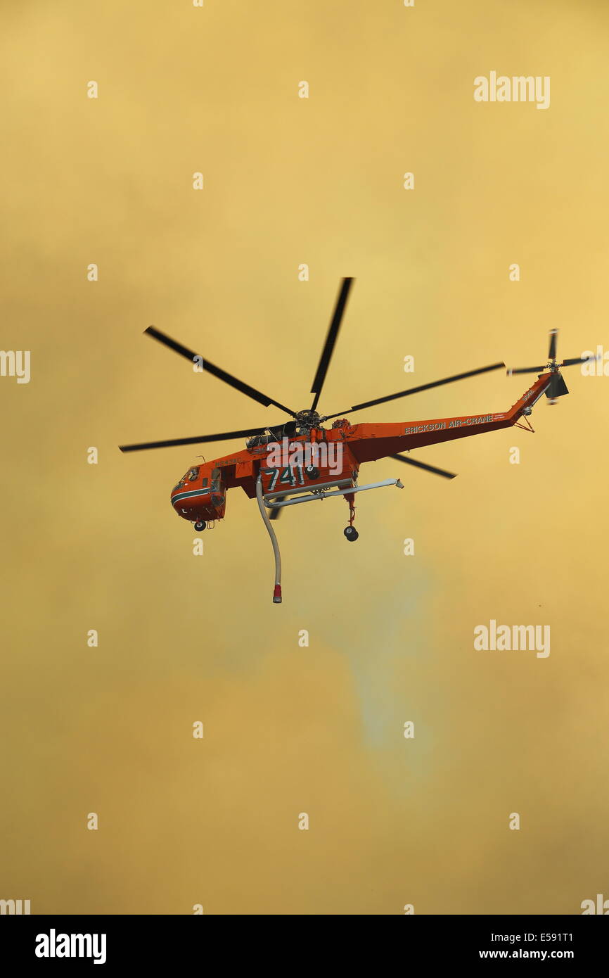 Aerial fire fighting a bush fire using water bomber helicopter in