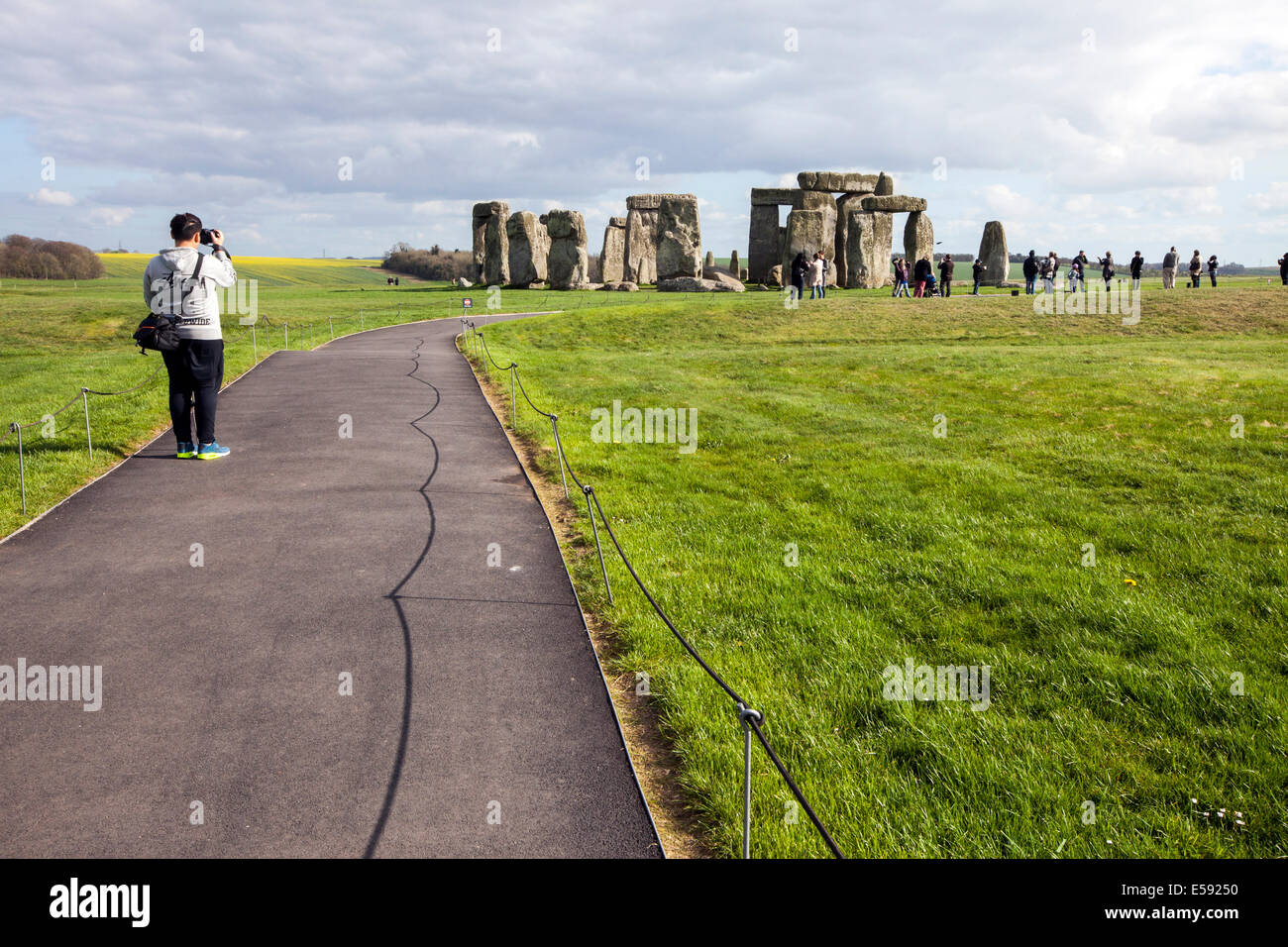 Tourists photograph the stones at the standing stone circle at Stonehenge, Wiltshire, UK Stock Photo