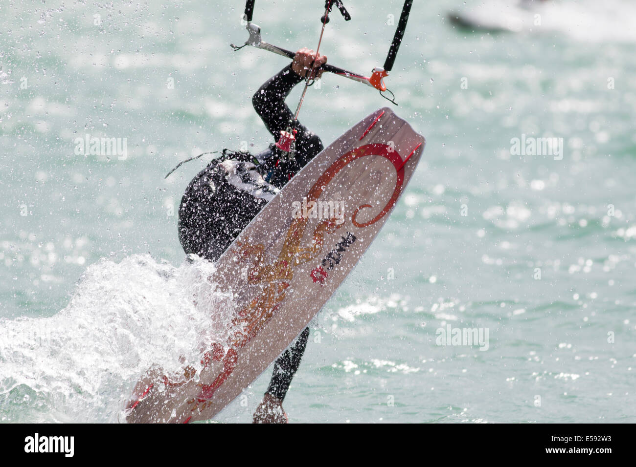 LAKE OF SANTA CROCE, ITALY - JULY 13: Professional kite-surfer demonstrating his ability 2014, July 13, 2014 Stock Photo