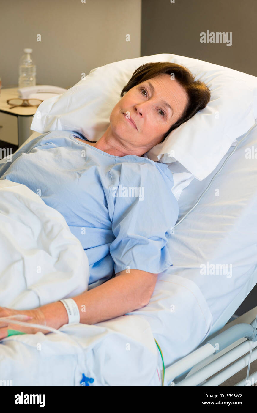 Woman lying in hospital bed Stock Photo - Alamy