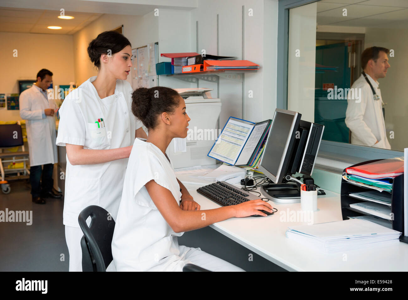 Intern nurse and doctor working in nurses office Stock Photo Alamy