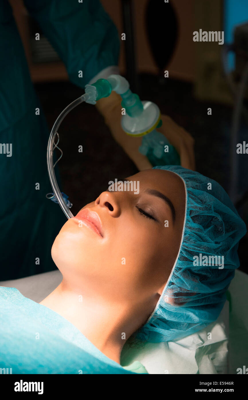 Patient with oxygen mask in an operating room Stock Photo