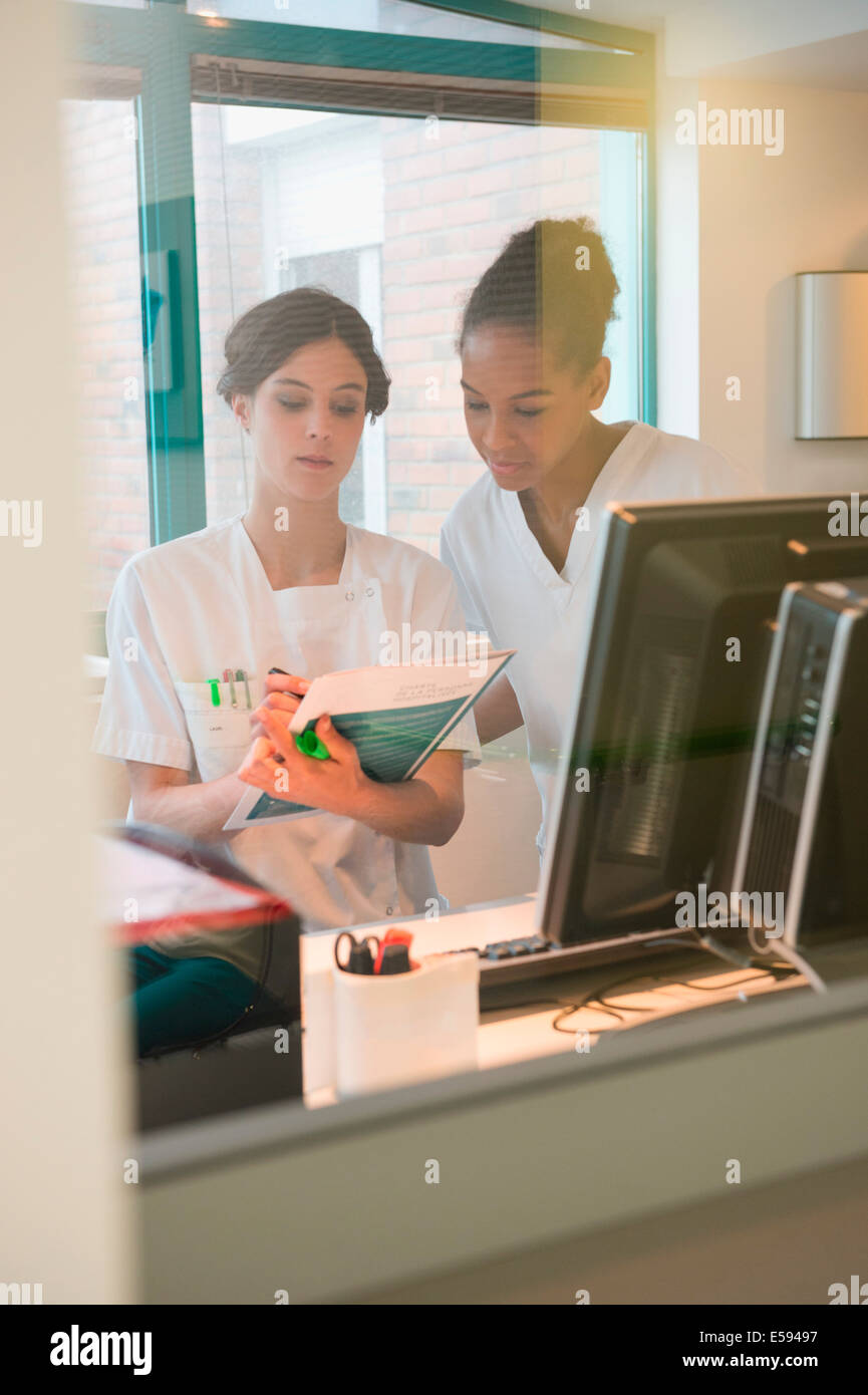 Two female nurses working in office Stock Photo Alamy