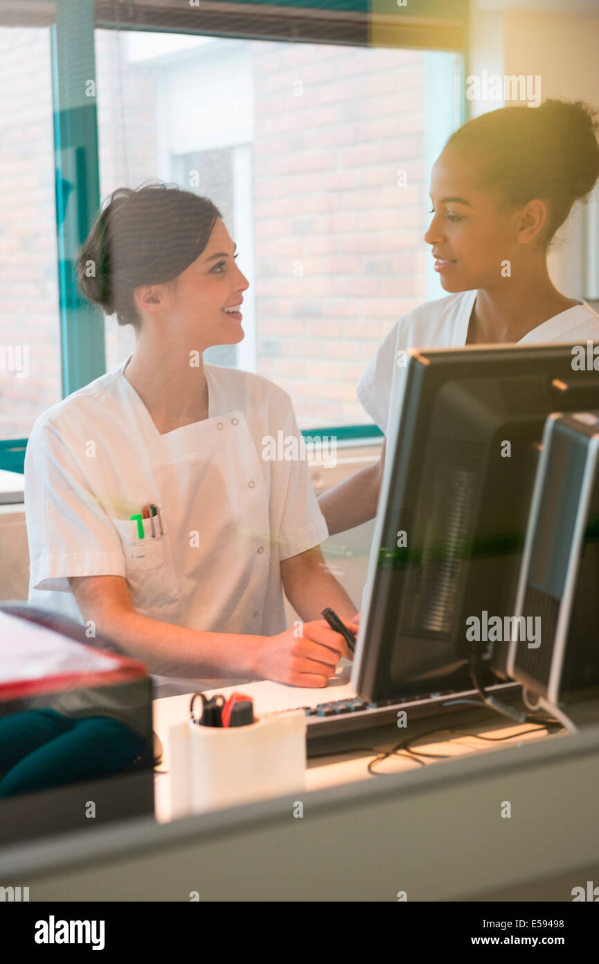 Two female nurses working in office Stock Photo Alamy