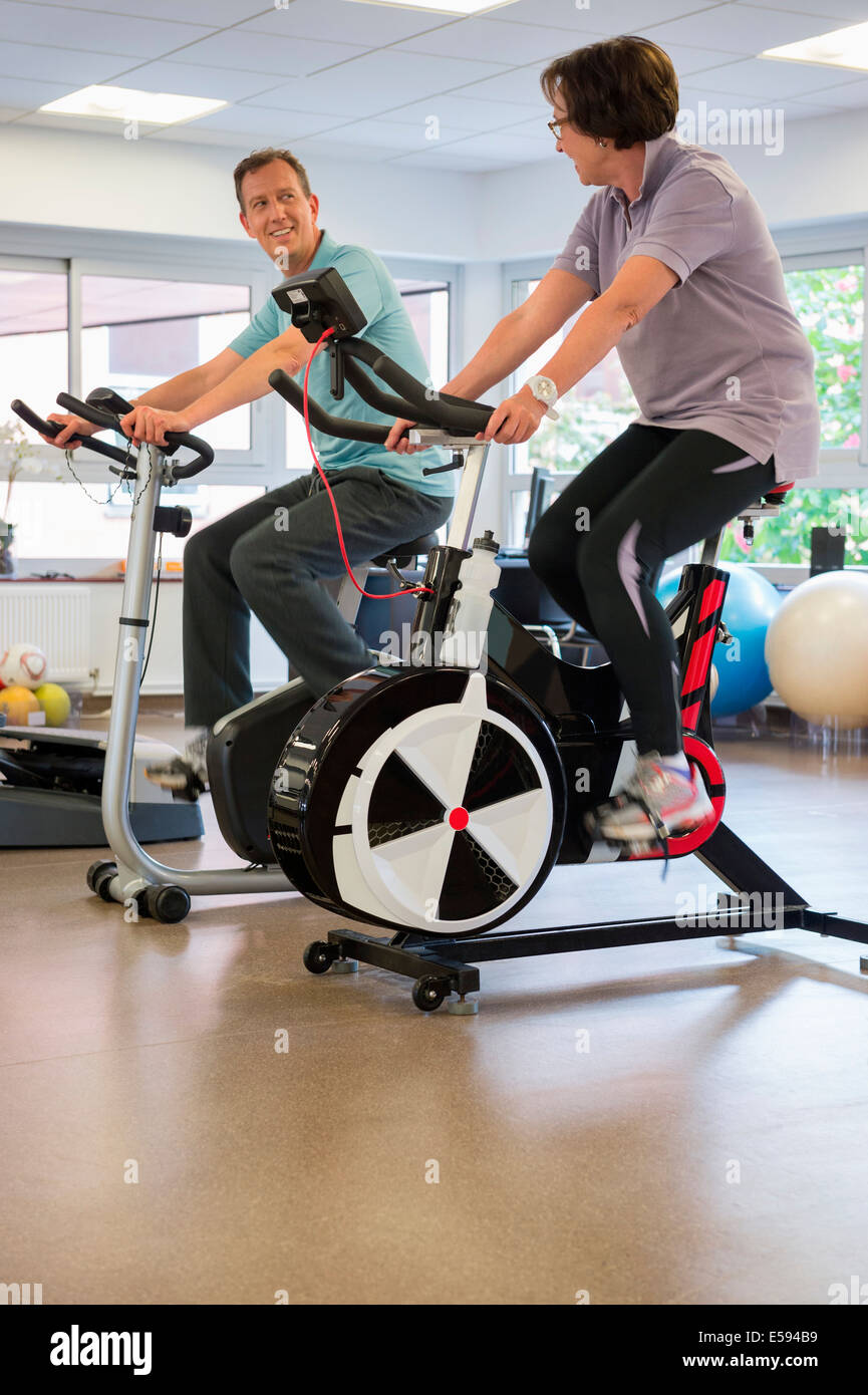 Man and woman in a spinning class at the gym Stock Photo