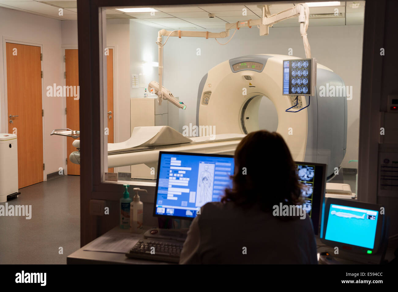 Medical practitioner examining MRI scan in monitor room Stock Photo Alamy