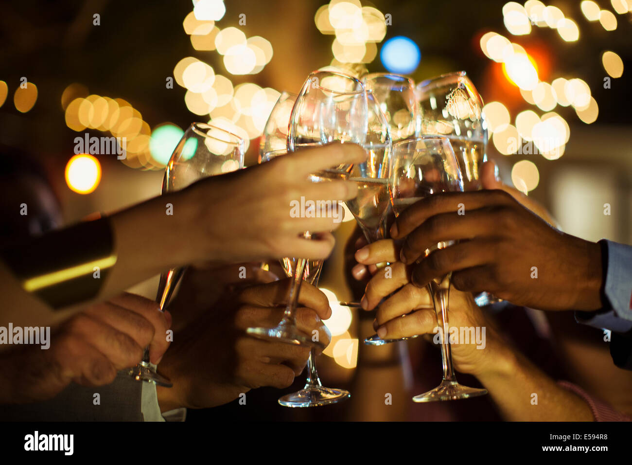 Friends toasting each other at party Stock Photo