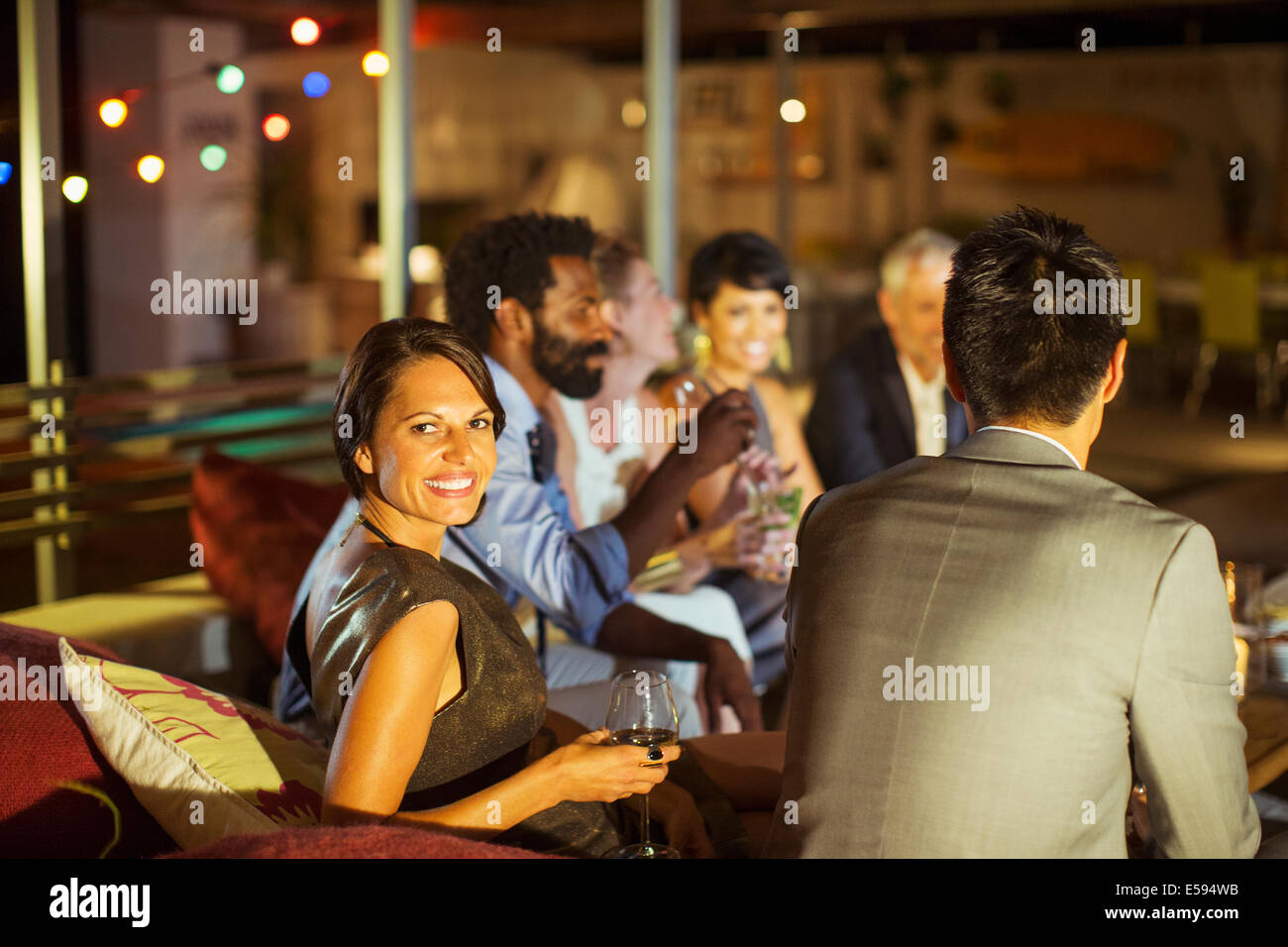 Friends relaxing together at party Stock Photo