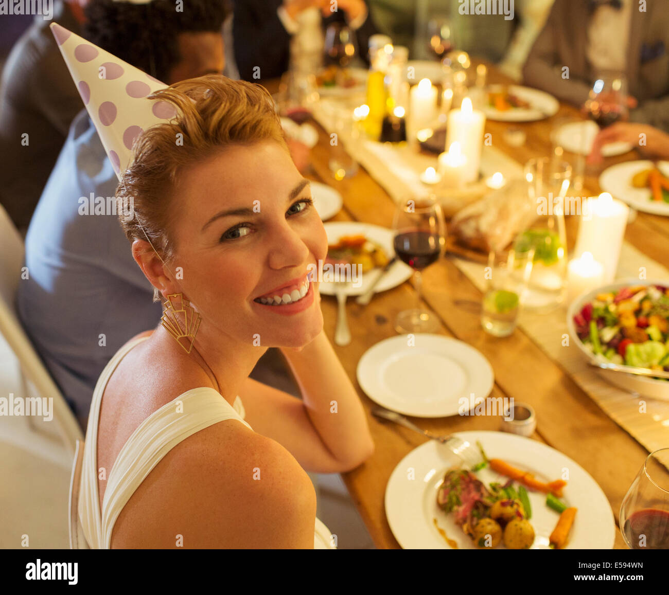 Woman smiling at birthday party Stock Photo