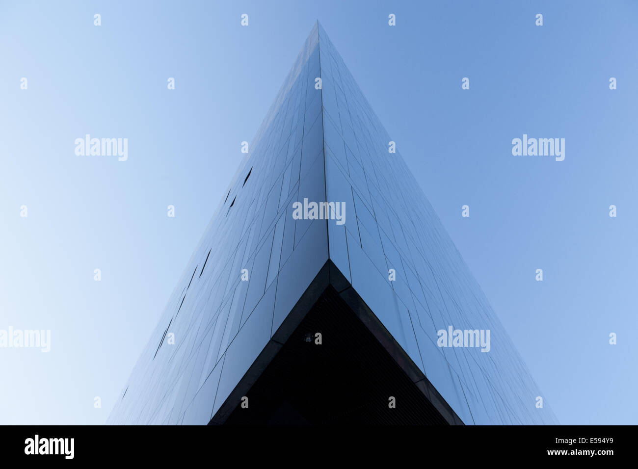 A semi-abstract architectural image of Mann Island in Liverpool Docks reflecting early morning blue light. Stock Photo