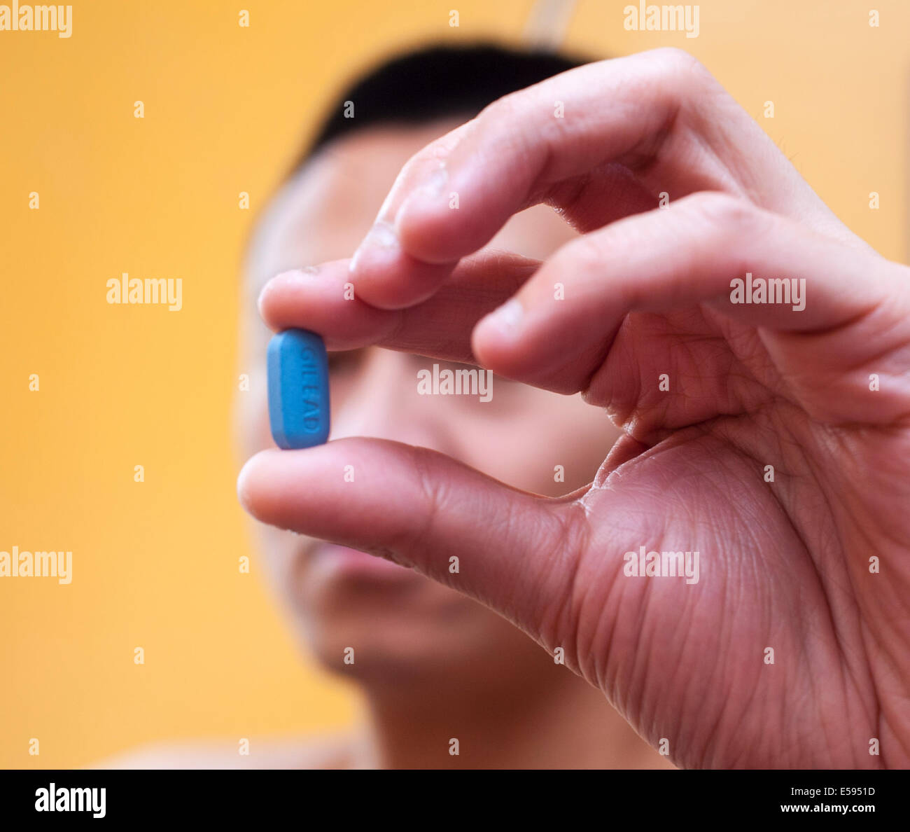 Man Holding Truvada Pill, HIV Anti-Viral medication, in Hand, AIDS HIV Prevention  PrEP 'Pre Exposure Prophylaxis' Close up Tablets, Clinical research trials, pharma industry Stock Photo