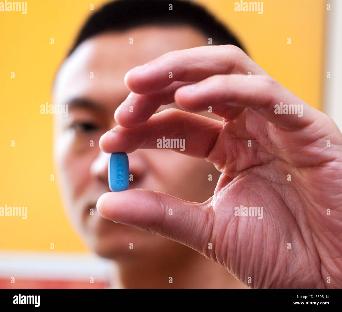 Man Holding Truvada Pill, HIV AntiViral medication, in Hand AIDS HIV