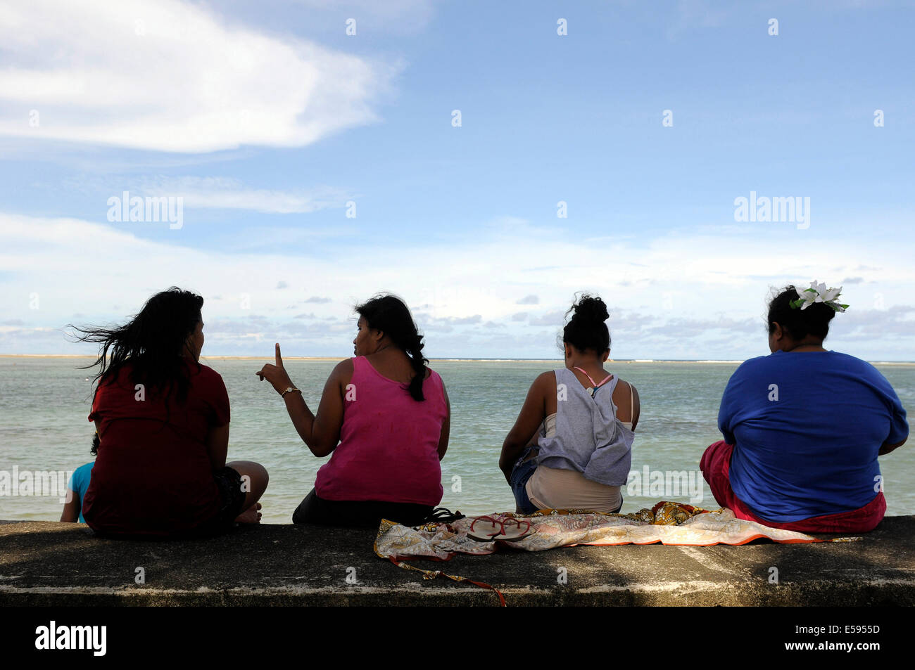 Travelling through Samoa in February 2014. Women sitting on a wall. Stock Photo
