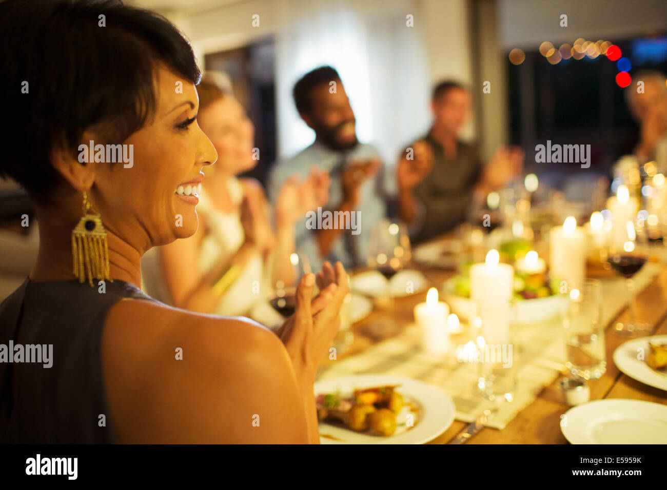 Friends applauding at dinner party Stock Photo