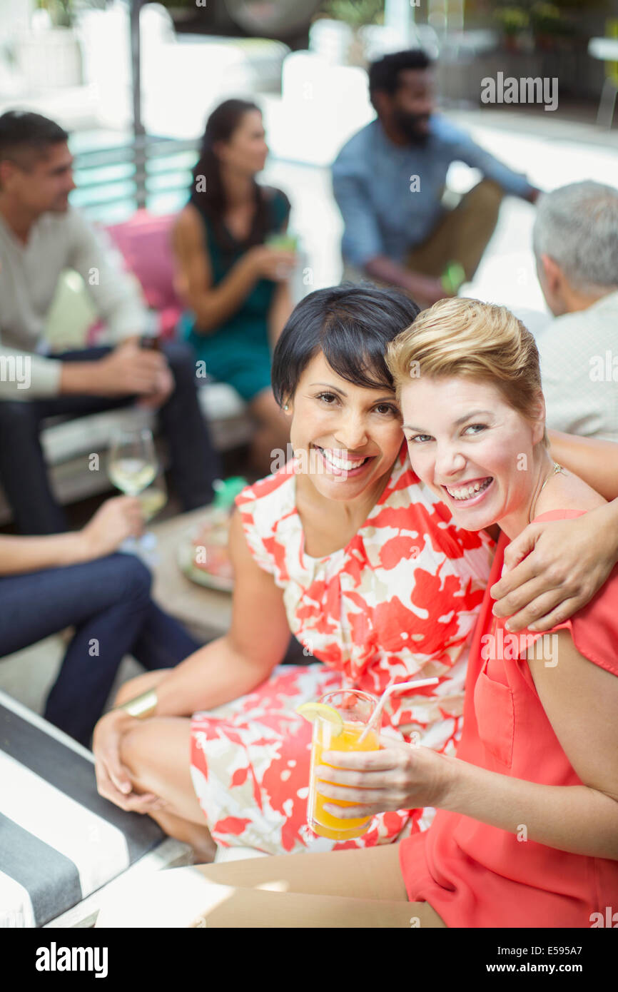 Women hugging at party Stock Photo