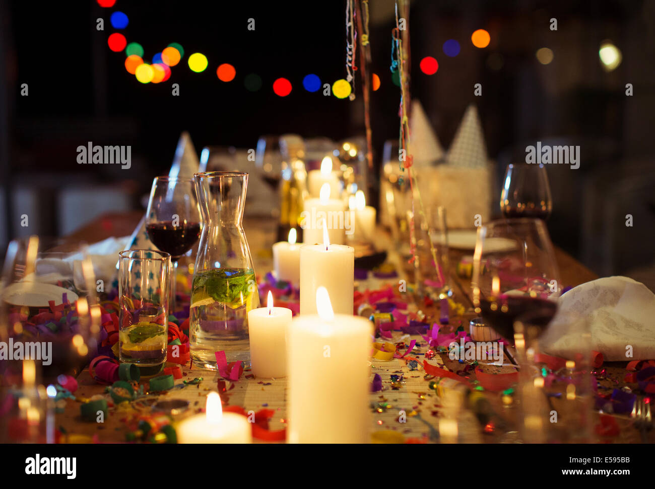 Lit candles on table at party Stock Photo
