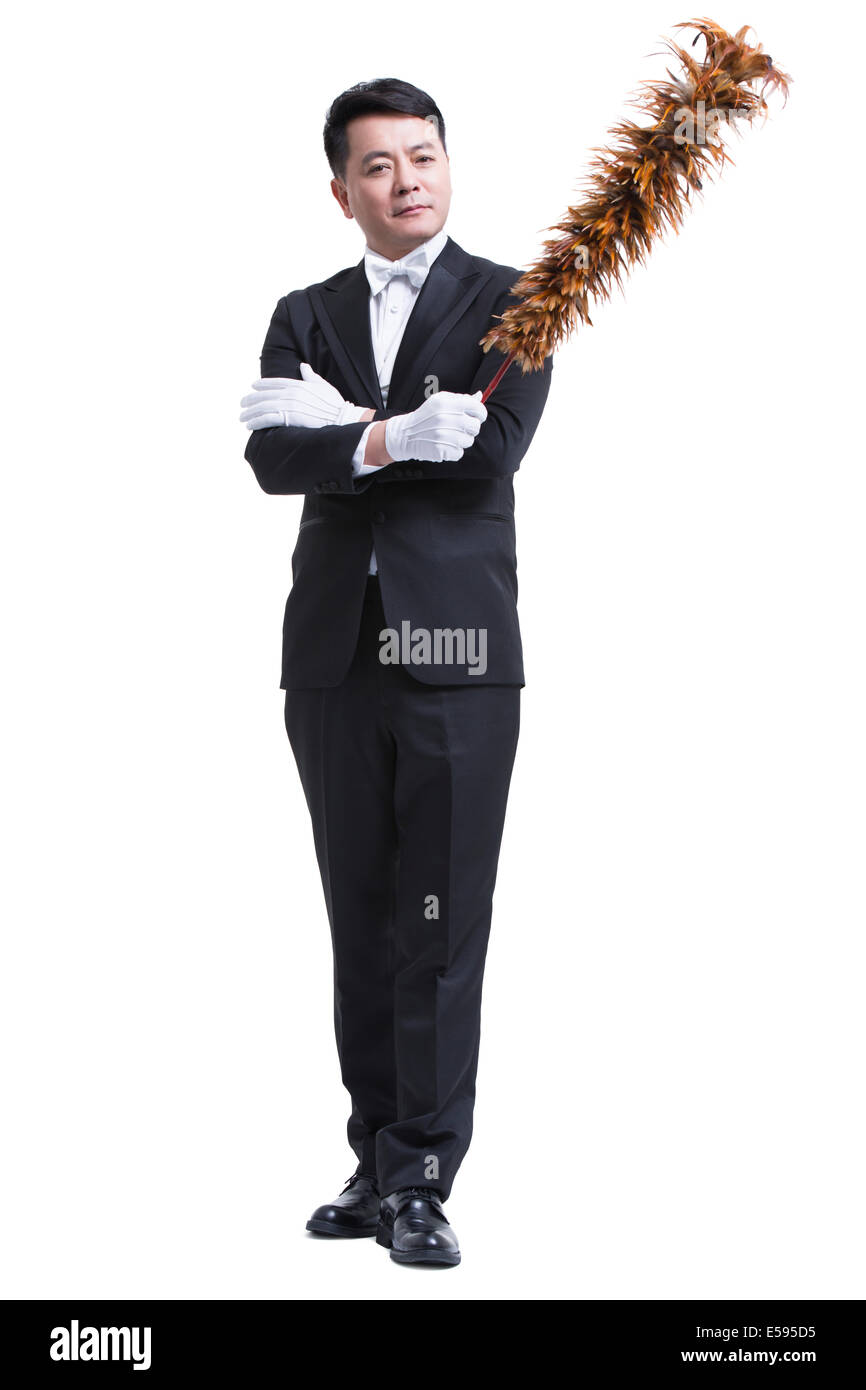 Male servant with duster Stock Photo